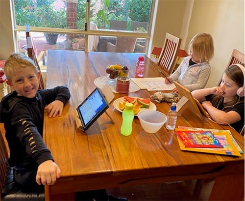 Laura's children gather around a table and enjoy some activities during isolation