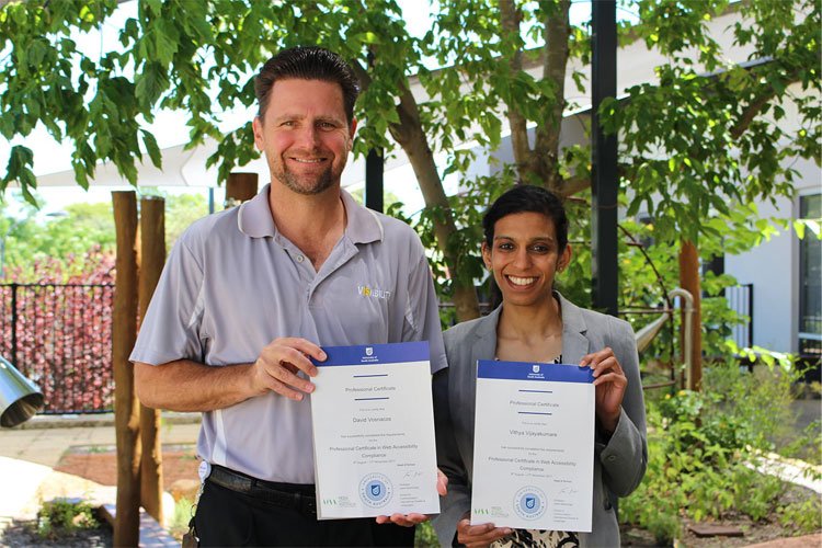 David and Vithya, standing in a VisAbility garden holding their certificates