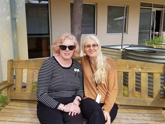 Marija Clark on bench next to Tanya Hinksman in garden