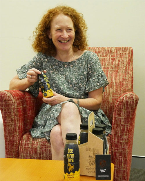 VisAbility team member Leone, with the Bee Firm NRG bottles with braille