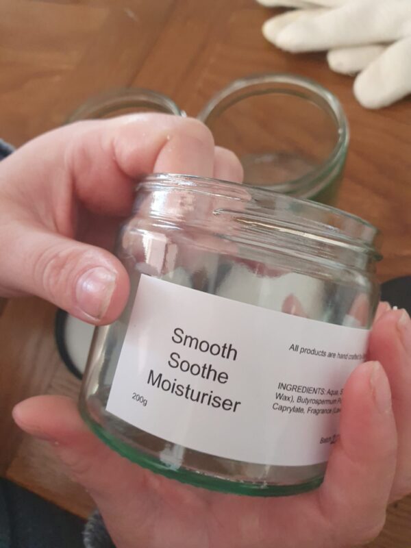 Sham holds a jar with label that reads Smooth Soothe Moisturiser 