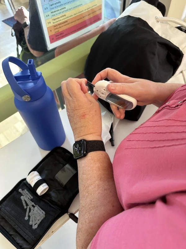 Jenny uses the Talking Glucometer to measure her blood sugar levels after exercising.