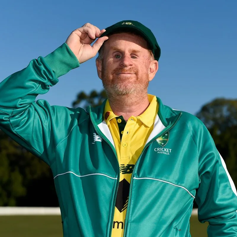 Ryan wearing another Australian cricket uniform and tilting his baggy green hat.